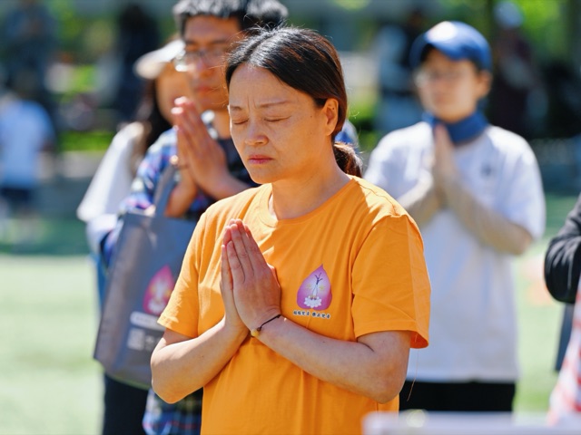Participants in silent practice with palms joined